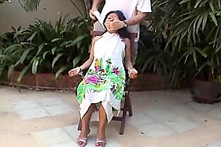 Asian teen tied up and hand cuffed on a chair 8 min